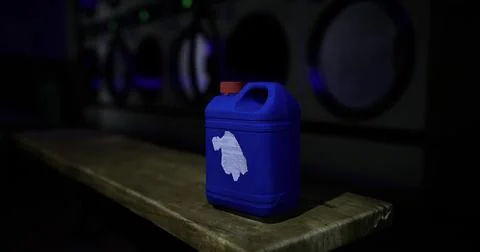 Blue container on wooden surface in a dimly lit laundromat at night Stock Illustration