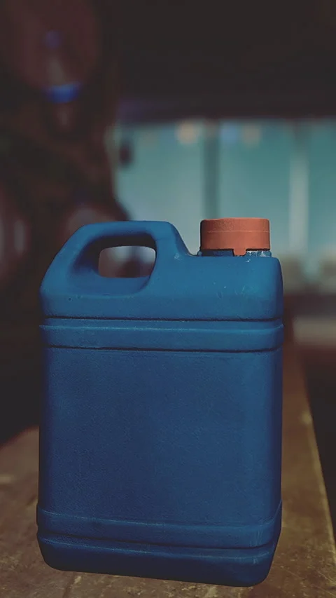 Blue container on wooden table in dimly lit laundry room at night Stock Footage 325074631