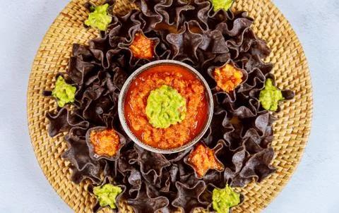 Blue corn tortilla chips with salsa and guacamole. Mexican food. Stock Photos