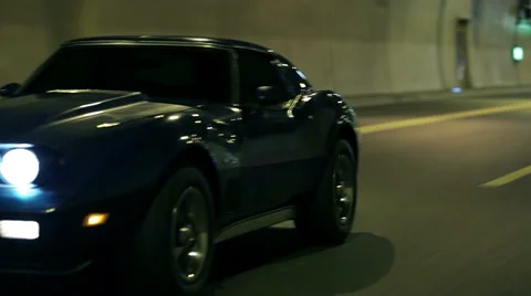 Blue Corvette driving through tunnel Stock Footage 33003134