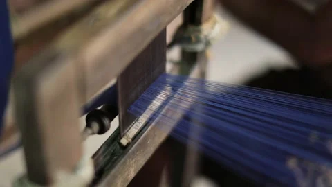 Blue cotton threads woven in machine in cloths and textile manufacturing Stock Footage 131346284