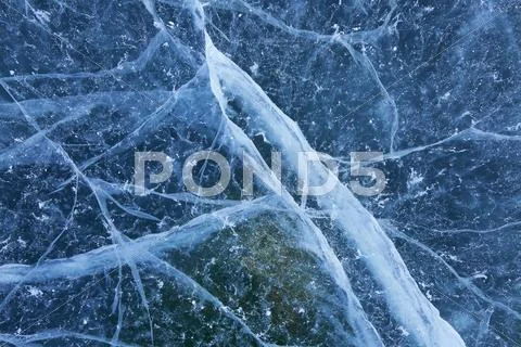 Blue cracked ice background Stock Photos