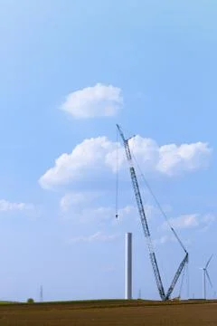 Blue crane tower constructing windmill with background of blue sky. Wind Turb Stock Photos