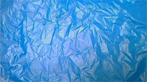 Blue crumpled plastic bag texture background rotating. HDPE Polyethylene Stock Footage 316378116