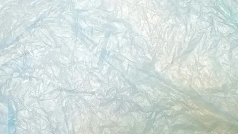 Blue crumpled plastic bag texture background rotating. Low-Density Polyethylene Stock Footage 316378493