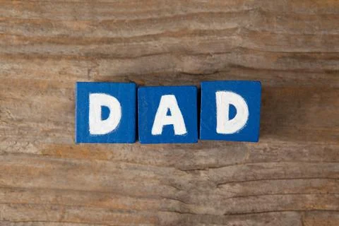Blue cube shapes with dad text on table Stock Photos