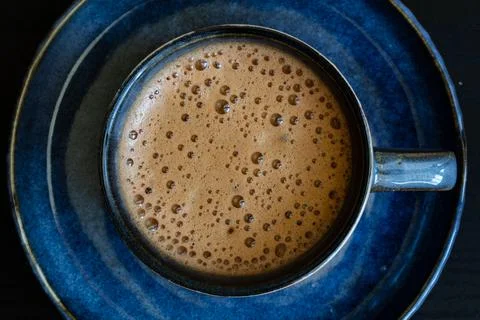 Blue cup of coffee on black background Stock Photos