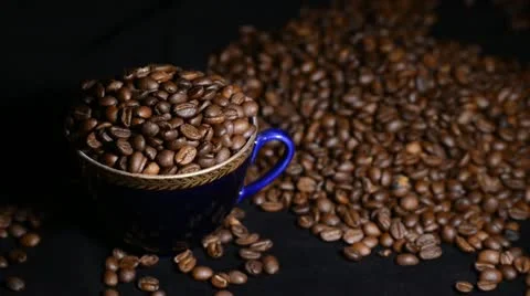 Blue cup full of coffee beans Stock Footage 22105539