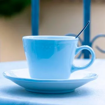 Blue Cup with a spoon on the table with the background blurred Stock Photos