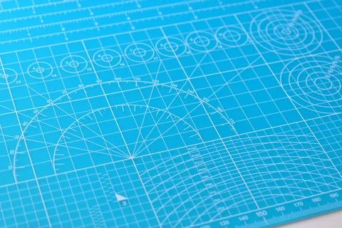 Blue cutting mat board background with line and scale measure guide pattern f Stock Photos