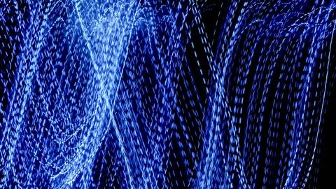 Blue dashed lines of lights on a black background Stock Photos