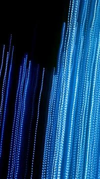 Blue dashed lines of lights on a black background Stock Photos