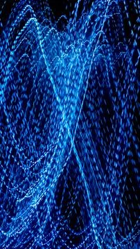 Blue dashed lines of lights on a black background 스톡 사진