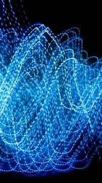Blue dashed lines of lights on a black background Stockfoto's