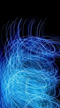 Blue dashed lines of lights on a black background 스톡 사진