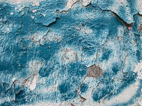 Blue decaying paint. Surface with damage and depressions. Stock Photos