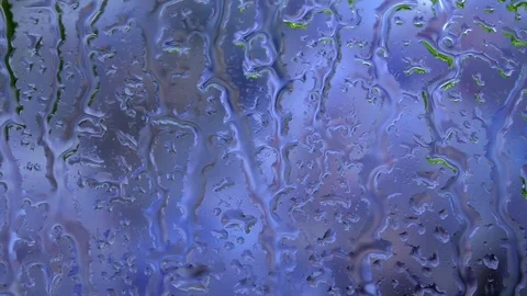 Blue defocused view through rainy window close up. Stock Footage 98680343