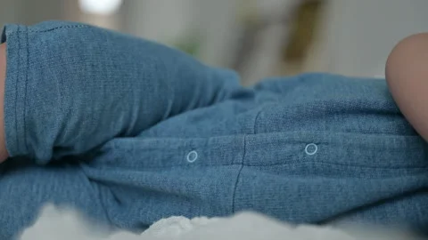 Blue Denim Fabric Closeup with Button and Folded Seam Detail Stock Footage 347017921