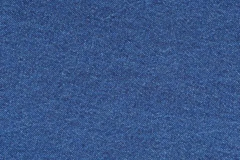 Blue denim fabric texture background. Detailed closeup of rugged cotton texti 库存照片