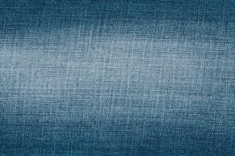Blue denim fabric texture close up. Woven material background for fashion a.. Photos