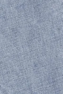 Blue denim fabric texture close up view. Detailed cotton textile pattern ba.. Stock Photos