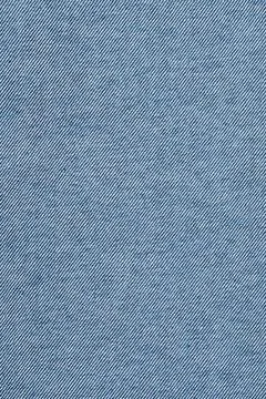 Blue denim fabric texture with diagonal weave pattern. Close-up of durable .. Stock Photos