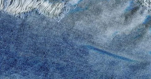 Blue denim jean texture background. Jeans torn fabric texture Fotos Stock