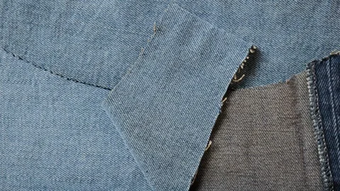 Blue denim jeans fabric texture rotating Stock Footage 340926721