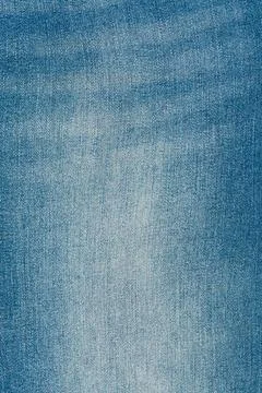 Blue denim jeans texture background with faded detail. Closeup of woven cot.. Stock Photos