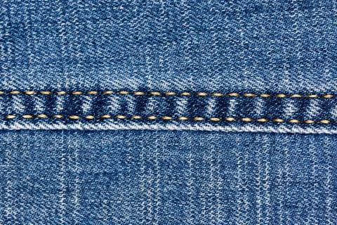 Blue denim texture. Macro photo of fabric Фото