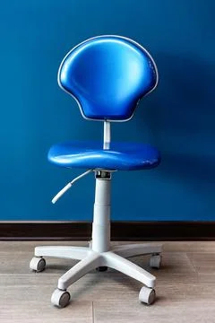 Blue dental operator stool in modern dental clinic Stock Photos