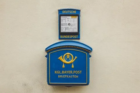 The blue Deutsche post mailbox, on the wall of a building in a German town Stock Photos