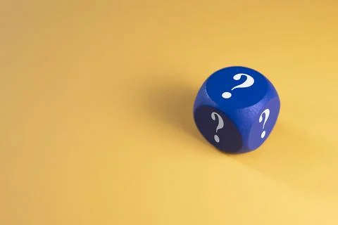 Blue dice with question mark on yellow background. Stock Photos