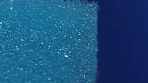 Blue dishwashing sponge in close-up smooth motion Stock Footage 128656166