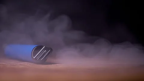 Blue Disposable Vape Pen Lying On Wooden Table Surrounded By White Swirling 库存影片 330116218