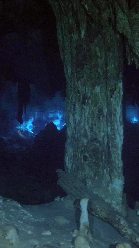 Blue diver light glowing beyond limestone columns Stock Footage 341361613