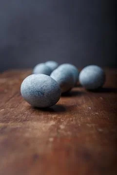 Blue diy painted easter eggs on brown wooden rustic table, grey background Stock Photos