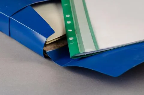 Blue document case on a gray background. Open case with folders for files, te 스톡 사진