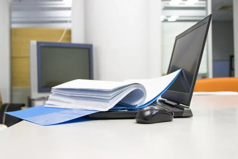 Blue Document folder with documents and Notebook on white table Photos