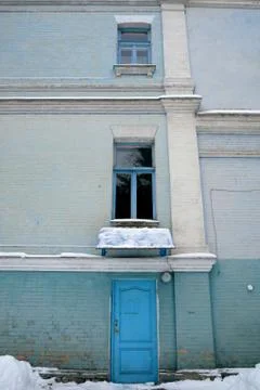 Blue door with two windows of the old house Stock Photos