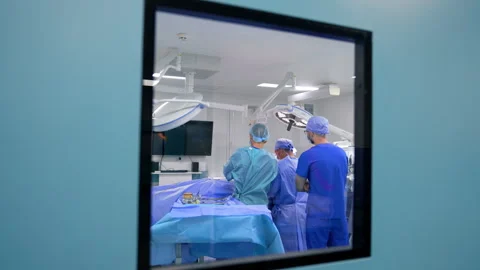 Blue door with a window to a modern surgery room Stock Footage 301646338