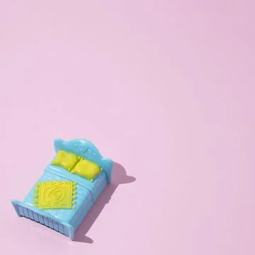 Blue double bed on a pink background, with copy space. Minimal flat lay com.. Stock Photos