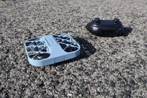 Blue drone and controller on asphalt Stockfoto's