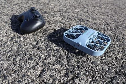 Blue drone and controller on asphalt Stock Photos