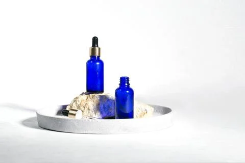 Blue dropper bottles on the white background Stock Photos