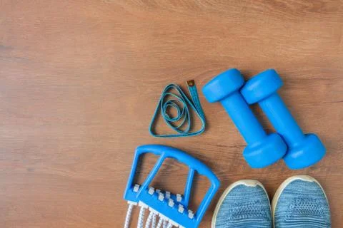 Blue dumbbells and chesty expanders on yoga mat. Fitness concept Stock Photos