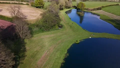 Blue dye used to surpress algae in two lakes. Gloucestershire. UK.  Stock Footage 274091077