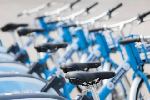 Blue e-bikes or bicycles in a row at a rental station or a shop - selective f Фото