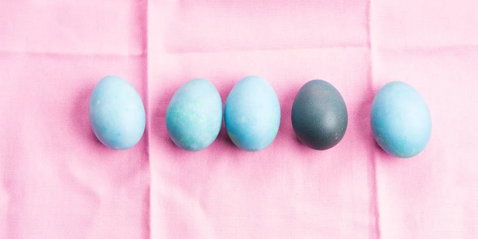 Blue easter boiled eggs on pink table cloth Stock Photos