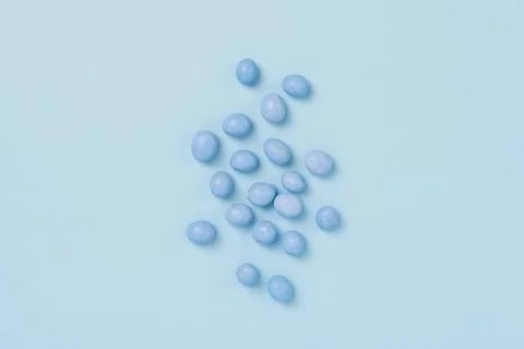 Blue easter dragee on a blue background Stock Photos